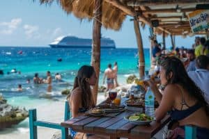 Tourists dining at a beachfront restaurant in Cozumel