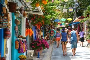 Tourists shopping at local artisan stalls.